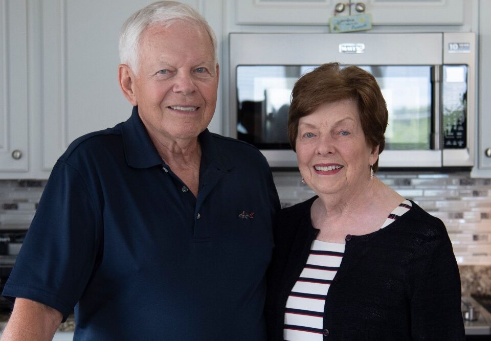 senior couple standing in kitchen togehter