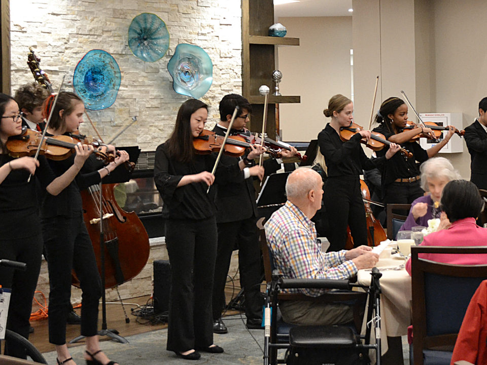 strings group performing to seniors