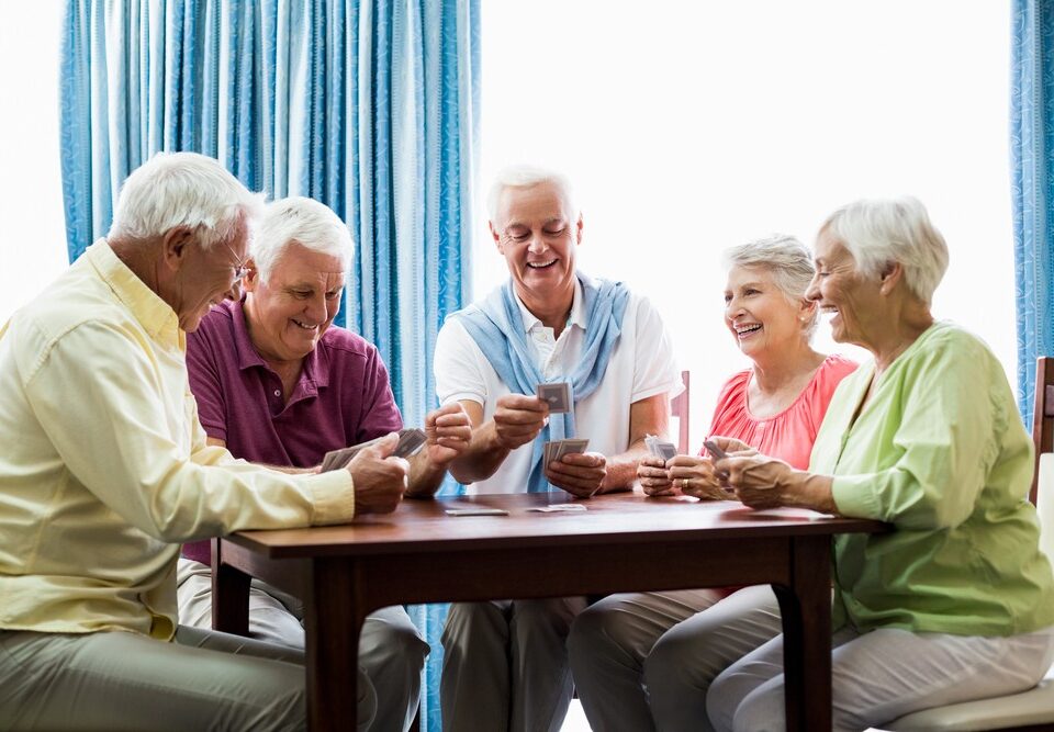 Seniors playing cards in senior living community