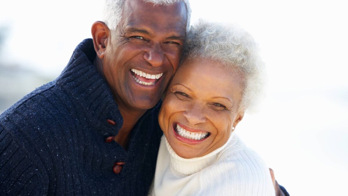 senior couple hugging and smiling on a sunny day