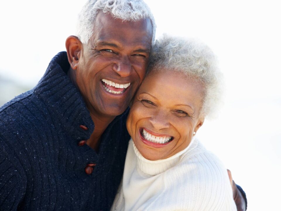 senior couple hugging and smiling on a sunny day