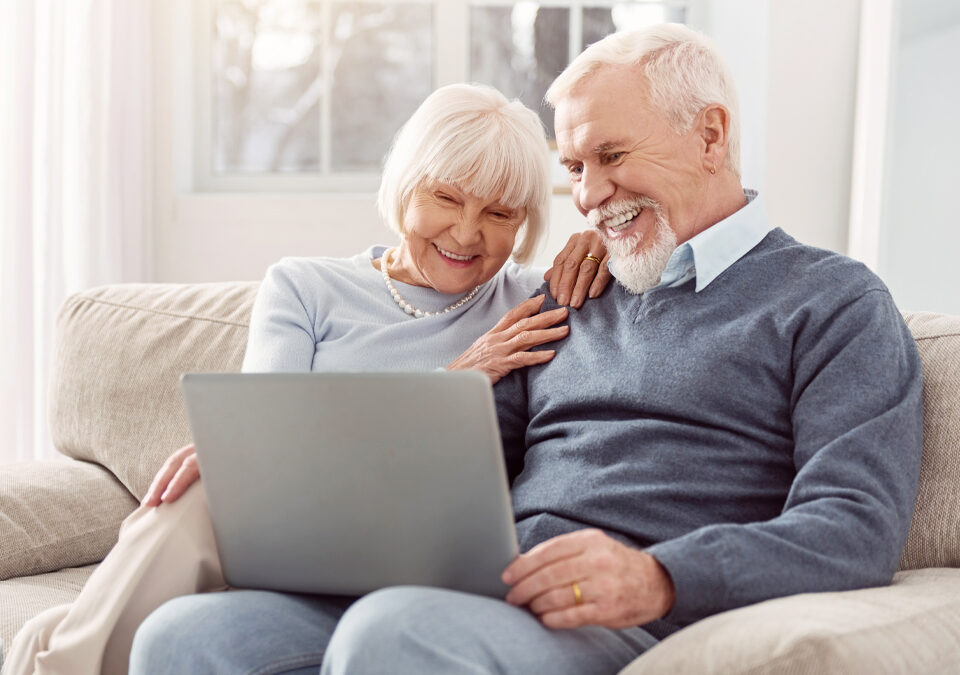 Senior couple looking at laptop