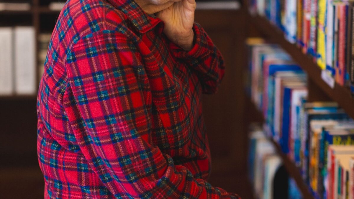 Senior resident reading in library at Friendship Village