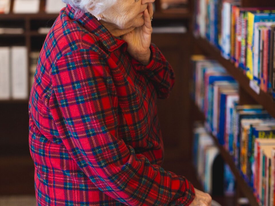 Senior resident reading in library at Friendship Village