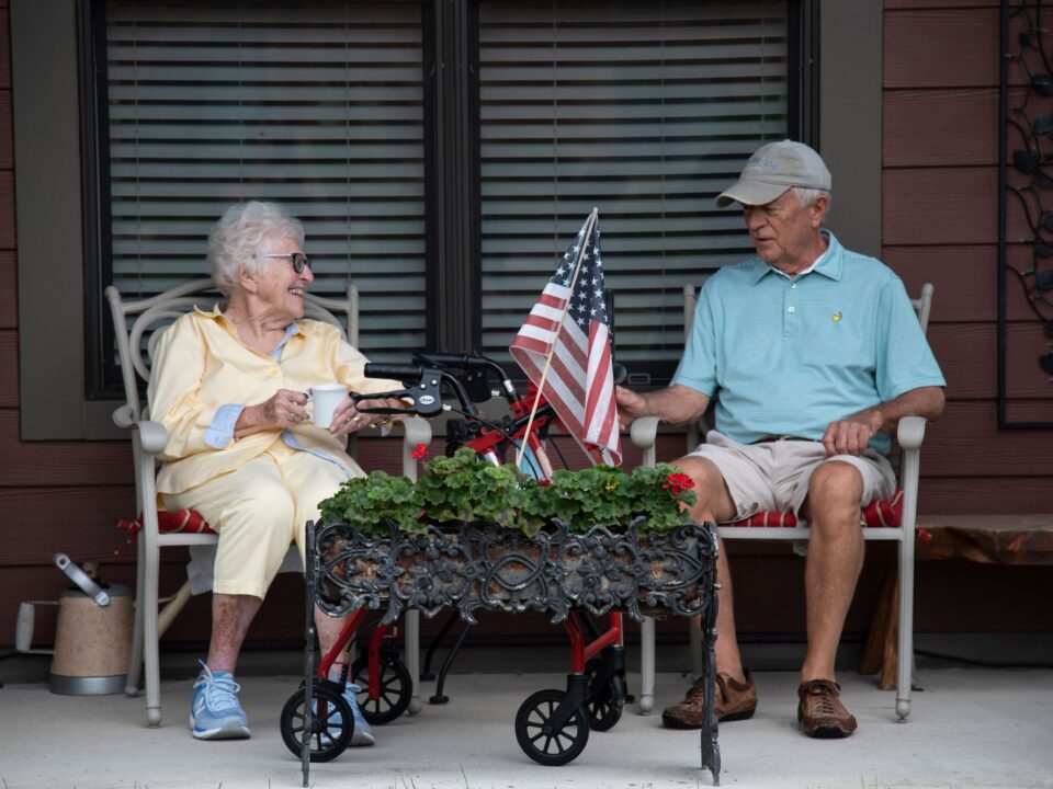 senior couple sitting outside on patio