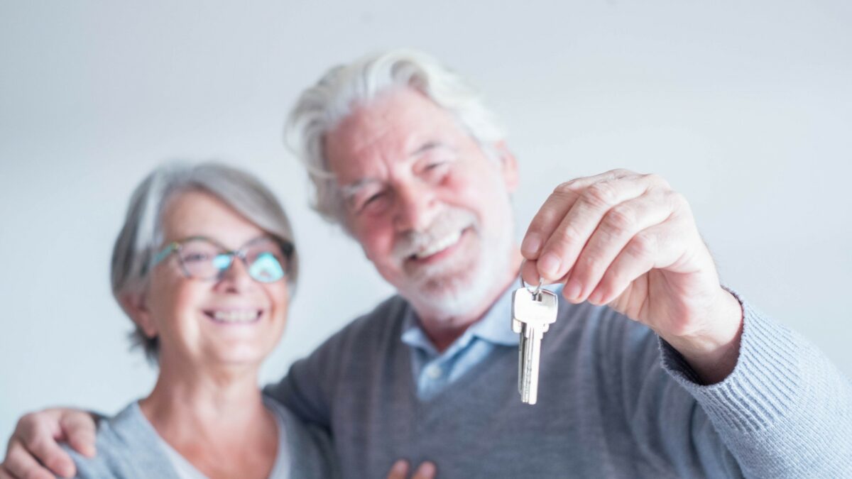 Senior couple holding a set of keys