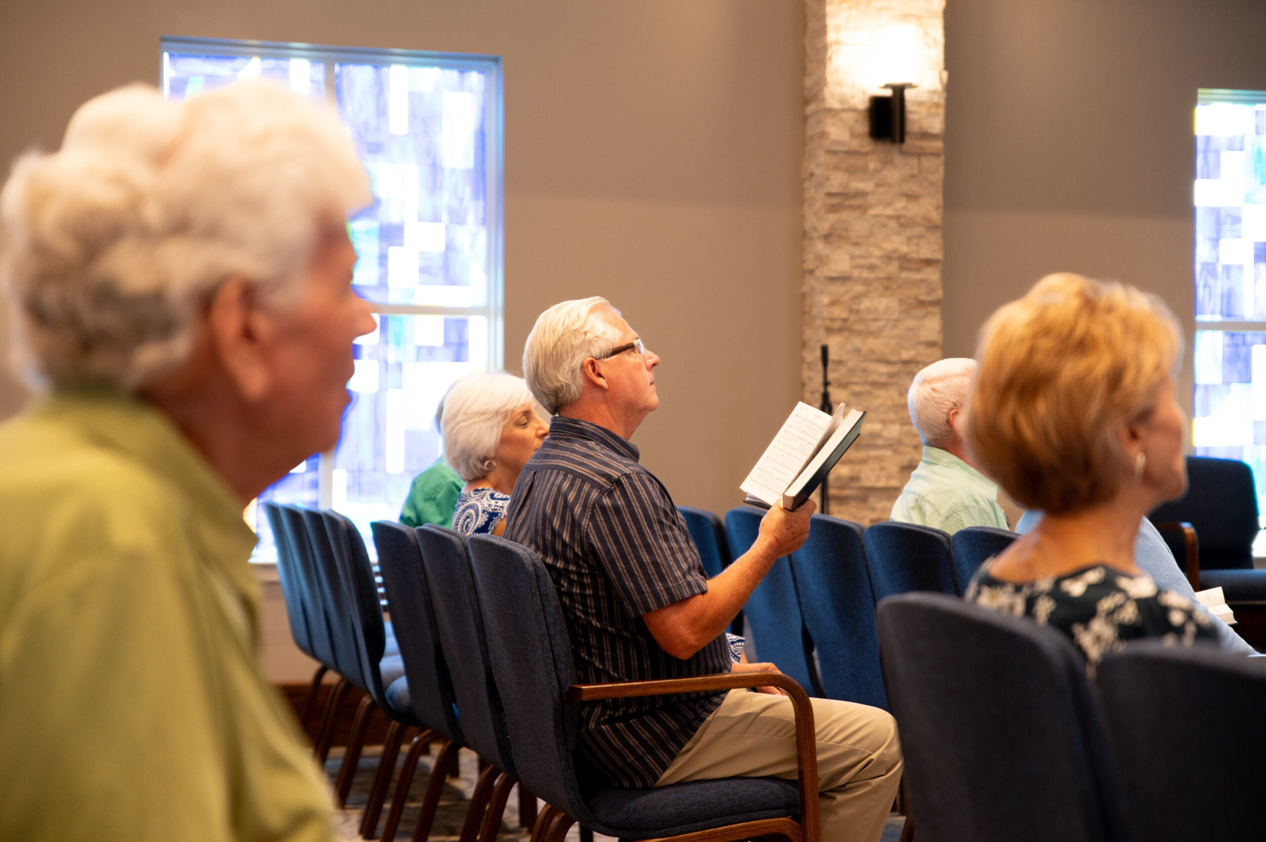 A group singing hymns at a service in the chapel.