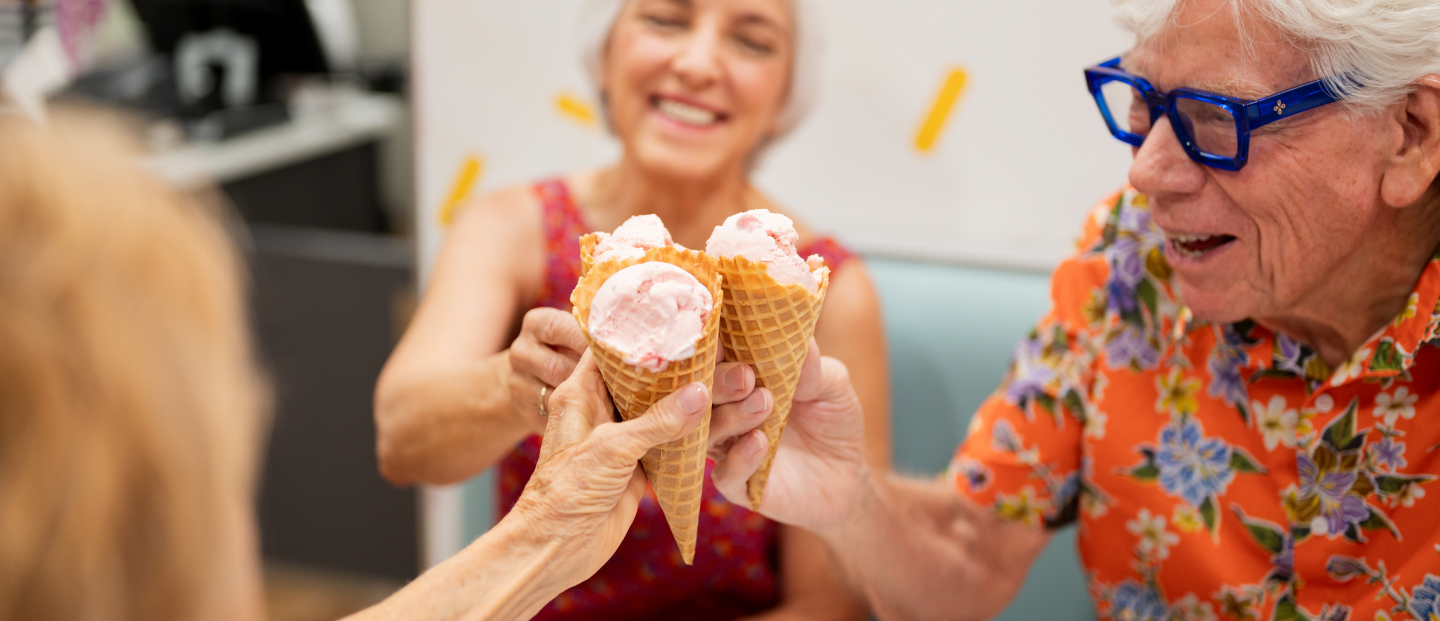 Three community members enjoying ice cream cones.